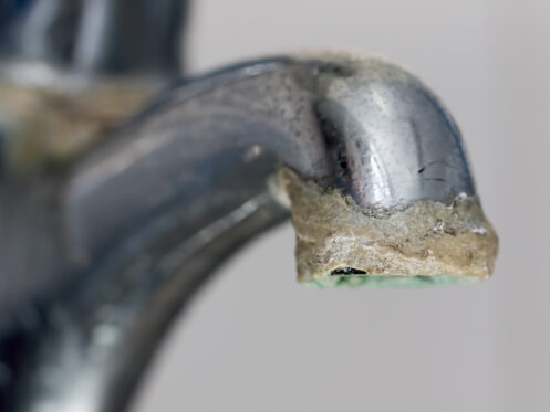 Hard water buildup on a faucet in Tucson